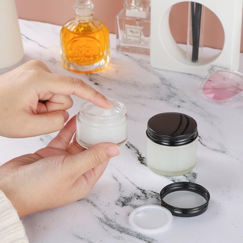RAMFIYN 12 Pack 1oz Clear Glass Jars Small Glass Containers with Black Metal Lids Empty Cosmetic Jars with Inner Liners and Lids Clear Glass Lotion Jars with Labels for Traveling