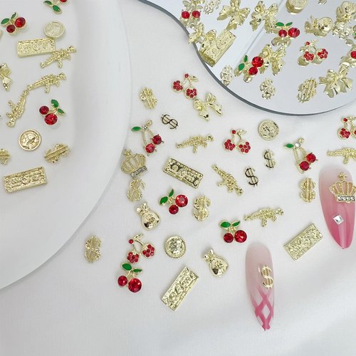 Pizadix 106 Pcs Gold Nail Charms with Dollars Sign, Coins, Cherries, Crowns, Guns and Bows for Nail Art Decoration Jewelry